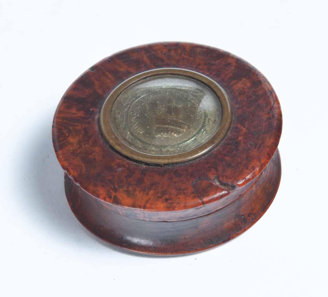 BURL SNUFF BOX WITH INLAID MEDALLION: Round with a flared base and lid. Inset brass medallion in lid "Hommage A Lafayette" covered by a curved glass dome. Brass portrait of Lafayette, modeled after the mature Caunois Bust. That portrait w
