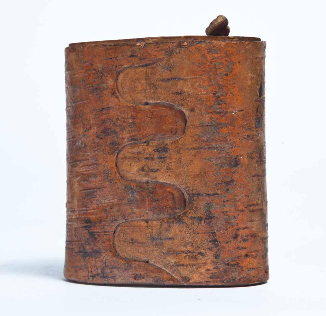 BIRCH BARK SNUFF BOX: Oval bent wood box with inset lid, probably Northern Minnesota. Lid with knotted leather thong handle. 3.75"h. 3"w. 1.75"d.