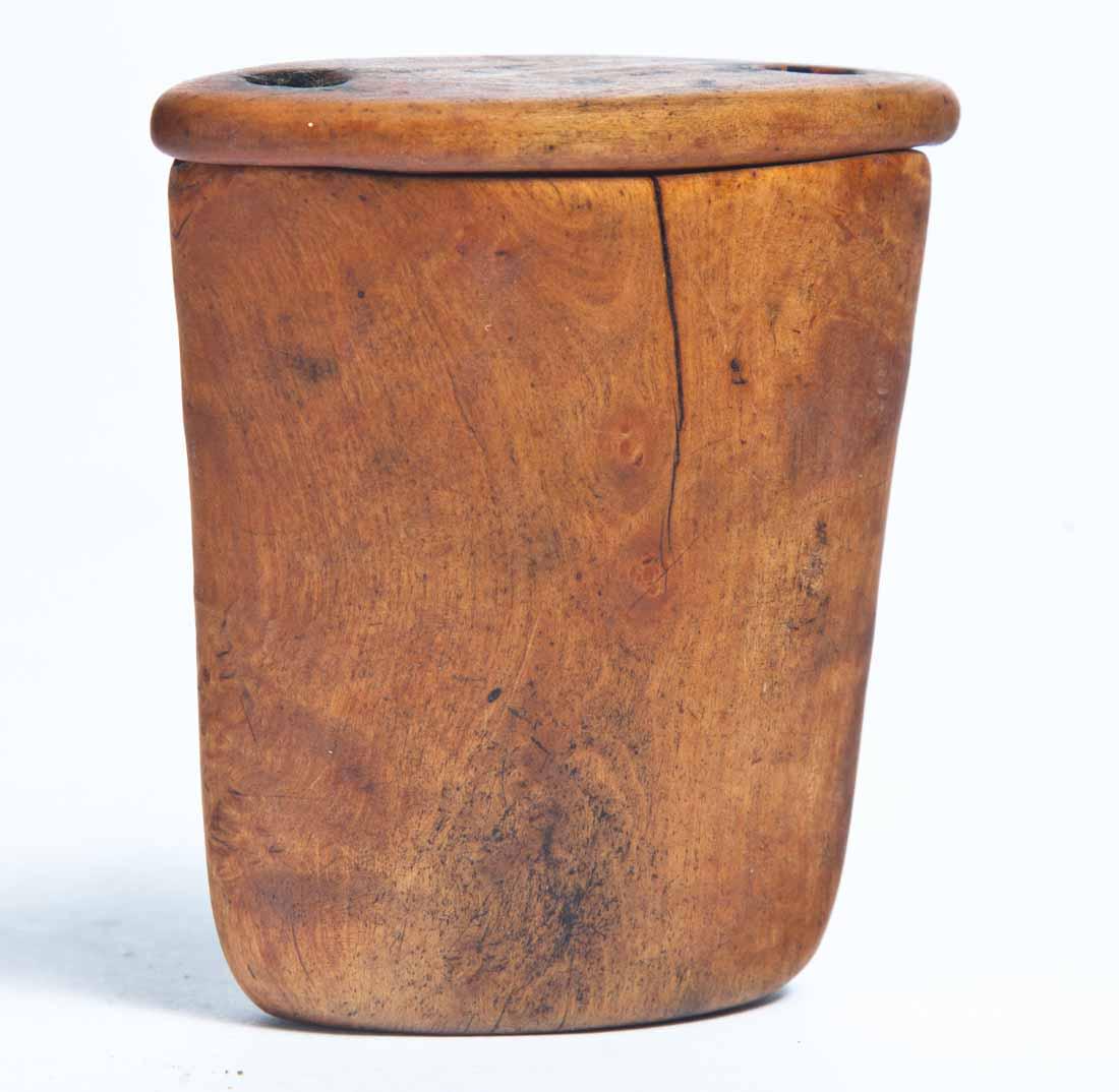 BURL SNUFF BOX WITH LID: Tapered oval form with good figure to wood. Hole at each end for leather thong to attach lid to base (missing). 2.75"h. 2.5"w. 1.5"d.