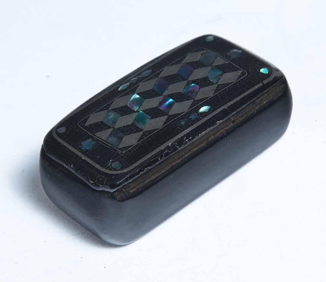 LACQUERWARE SNUFF BOX: Rectangular with rounded ends. Inlaid mother-of-pearl and pewter tumbling block decoration. .5"h. 2.5"l. 1.25"d.