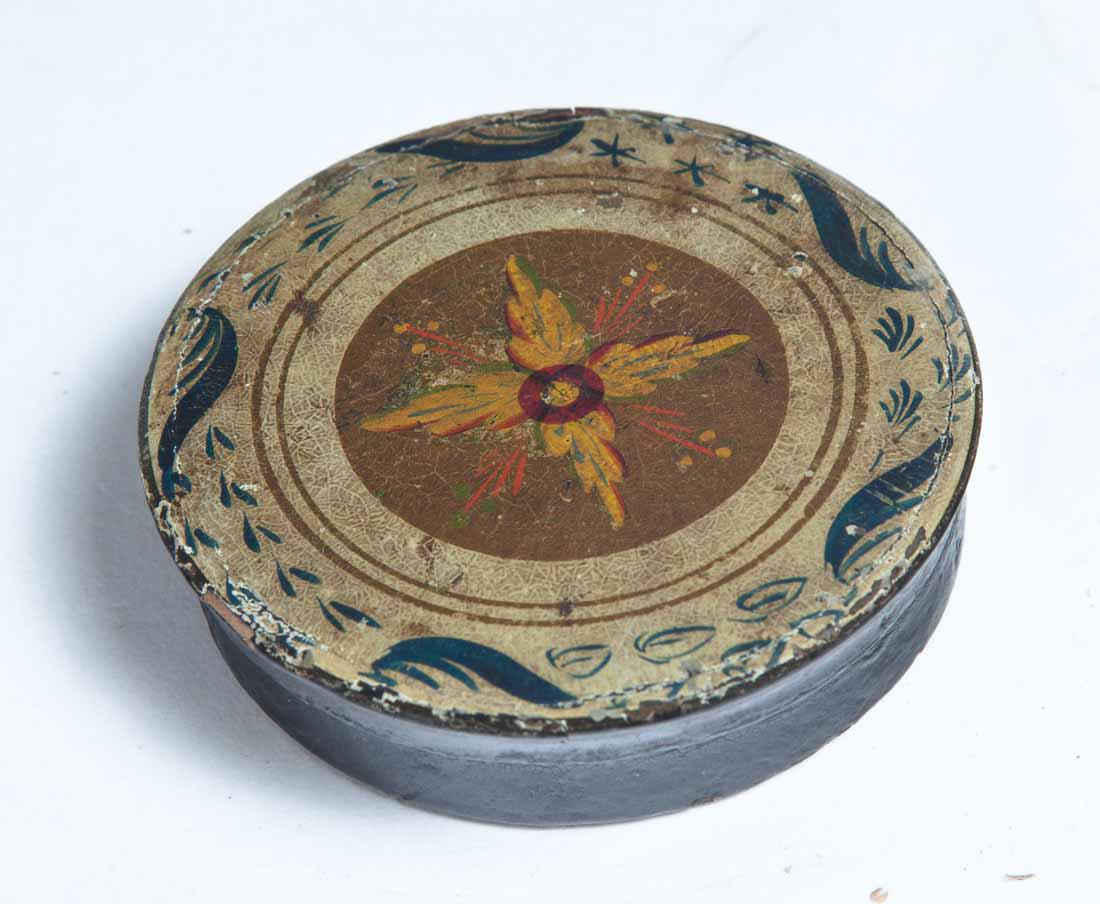 PAINT-DECORATED LACQUERWARE SNUFF BOX: Round with paint decoration in white, blue, red, yellow and gold. Purchased from Garth's Auctions, Delaware, Ohio. .75"h. 3" dia.