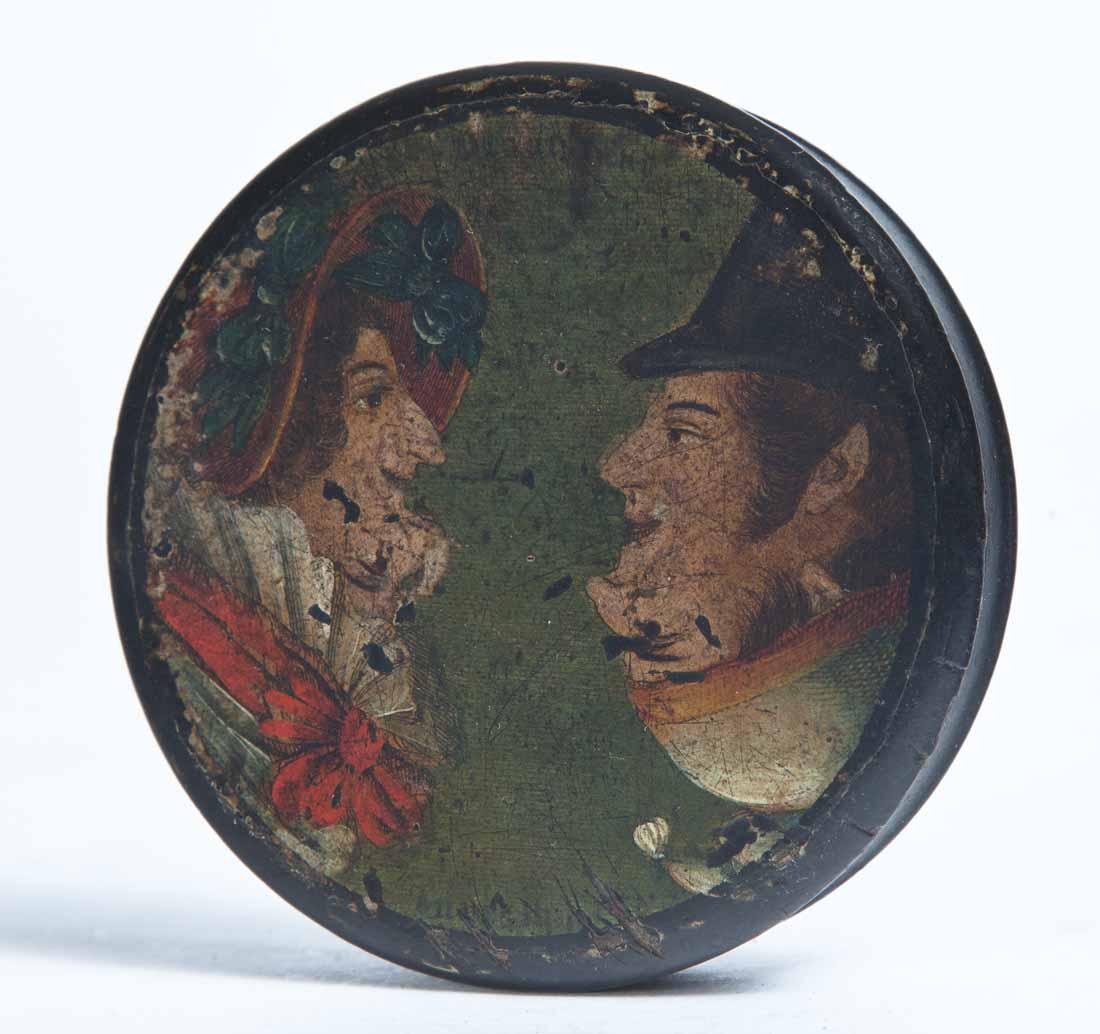 PAINT-DECORATED LACQUERWARE SNUFF BOX: Round with decoration of a man and woman in profile, possibly Punch and Judy. .75"h. 3.25"dia.