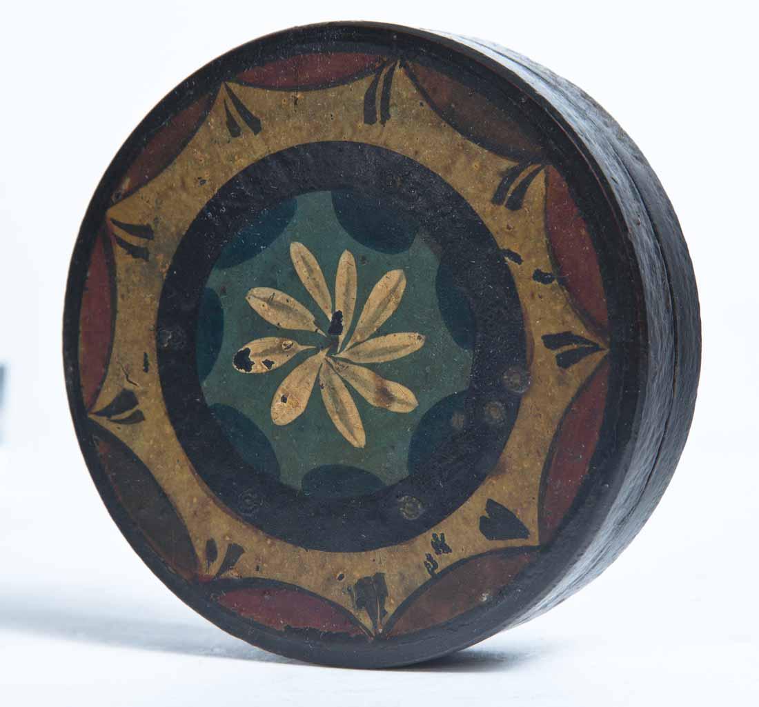 PAINT-DECORATED LACQUERWARE SNUFF BOX: Round with paint decoration in red, yellow, light blue and dark blue. 1"h. 3.5"dia.