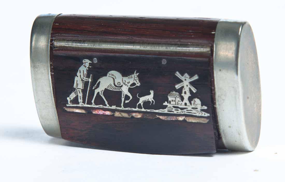 WOOD SNUFF BOX: Rectangular with rounded ends. Hinged lid with inlaid metal, probably unmarked silver, decoration of a man, mule and dog in the foreground and a windmill and houses in the background. Metal covers on 