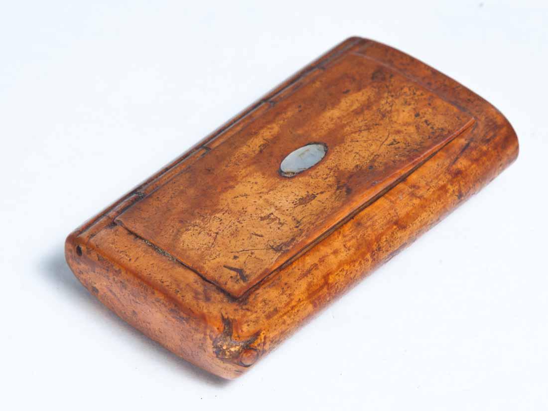 BURL SNUFF BOX: Rectangular with rounded ends and hinged lid. Inlaid oval mother-of-pearl medallion on lid. .5"h. 2.75"w. 1.75"d.