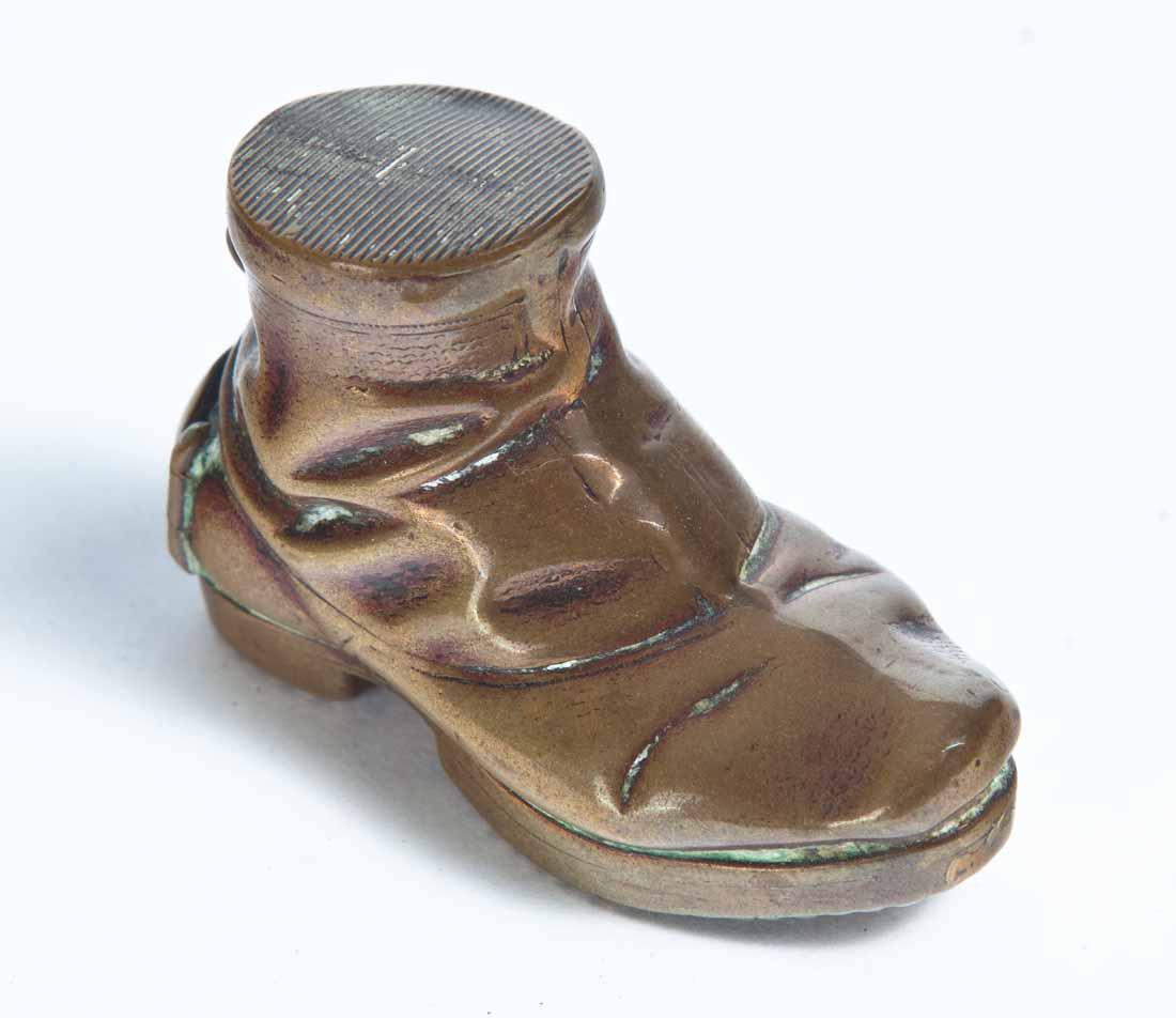 BRASS WORKMAN'S BOOT MATCH SAFE: Hinged door in heel and bale on back of shoe for wearing on a chain. 1.5"h. 2"w. .75"d.