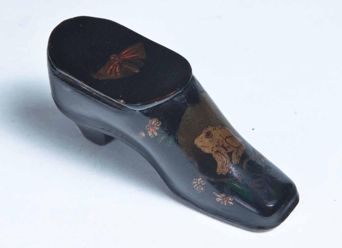 PAINT DECORATED LACQUERWARE SHOE SNUFF BOX: Heeled shoe with hinged lid and decoration consisting of a toad and flowers on the top and a butterfly on the lid. Purchased from Garth's Auctions, Delaware, Ohio. 1.5"h. 3.25"w. 1"d.