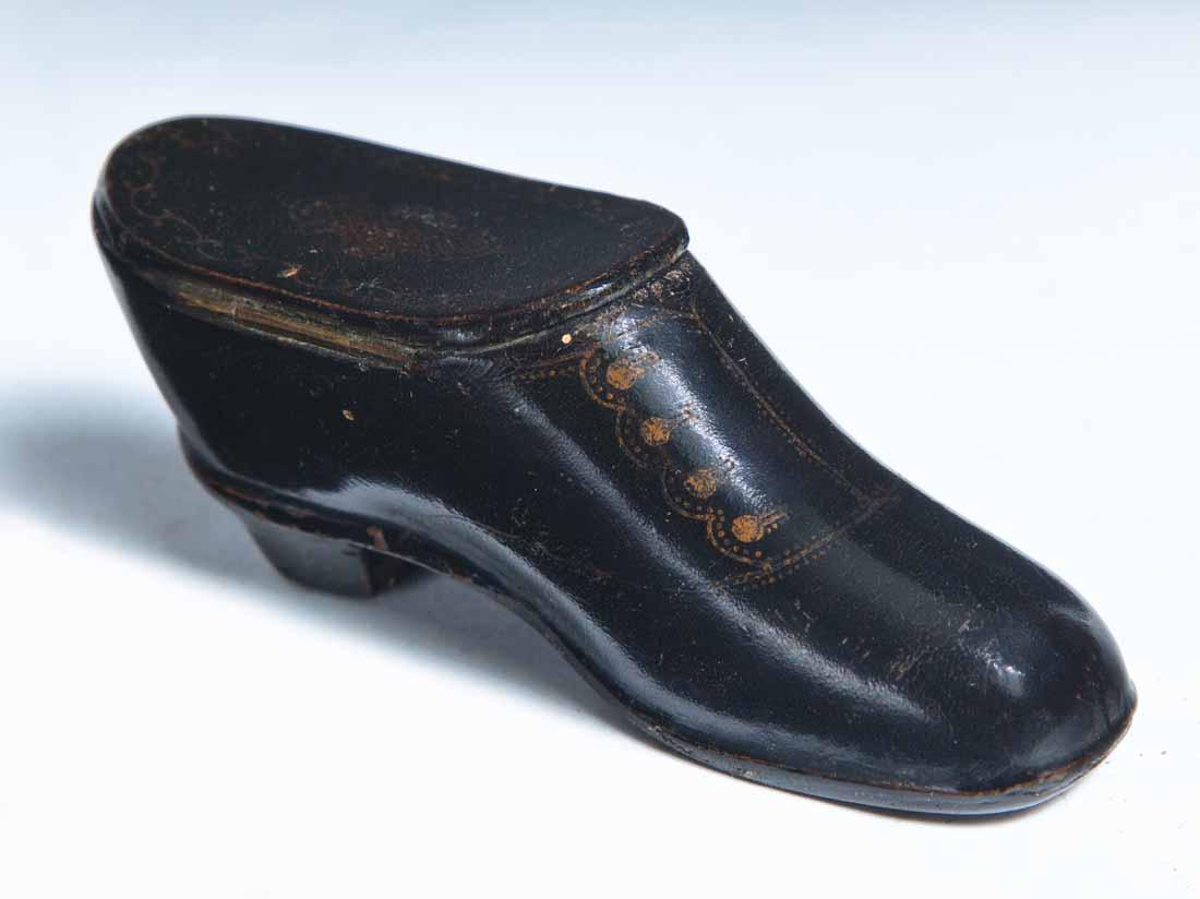 LACQUERWARE SHOE SNUFF BOX: Heeled shoe with hinged lid and paint decoration including buttons, stitching and scrolls on lid. 1.25"h. 3"w. 1"d.