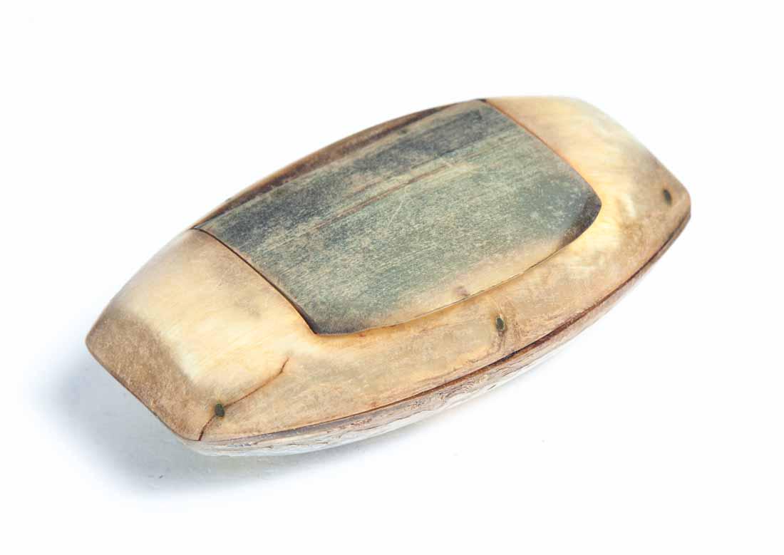 HORN SNUFF BOX: Oval with flattened ends and hinged lid. Nailed construction. 1"h. 3.5"l. 2"d.
