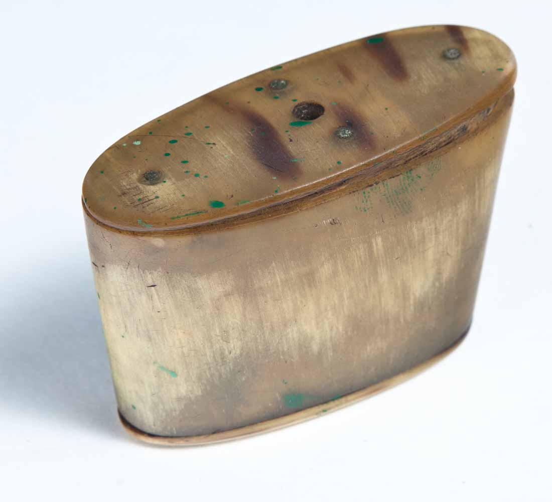 CARVED HORN SNUFF BOX: Oval horn segment with nailed construction, detached horn lid with wood liners inside lid and base. 1 .75"h. 2 .25"w. 1"d.