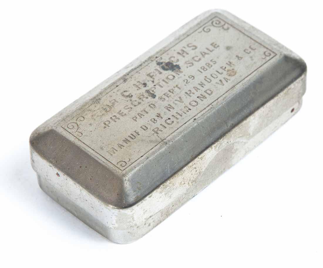TWO POCKET MEDICAL DEVICES: A "Dr. Fitch's Prescription Scale" in metal case. .75"h. 2 .75"w.1 .5"d. A folding "Nelson-Baker & Co Iodosyl" needle sterilizer. 4"l (unfolded).