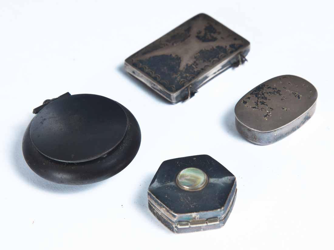 FOUR METAL PILL OR SNUFF BOXES: One round marked "Real Gunmetal, Germany". 1 .5"dia. One octagonal Mexican with inset mother-of-pearl on the lid. 1"dia. Two silverplate. 1"w. 1.5"w.