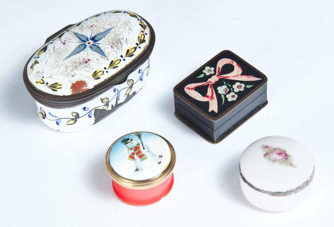 FOUR SMALL ENAMELED BOXES: Oval box with blue, yellow and red floral designs on a white ground 1"h. 2"w. 1"d. Round "Bilston and Battersea Enamels" box with snowman on lid. .75"h. One rectangular box with bow and flowers on lid