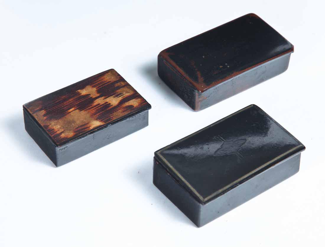 THREE SNUFF BOXES: All three black lacquerware. One marked "Made in France". 2 7/8"w. One with brass line inlay. 3"w. One with faux grain painting on lid. 2.5"w.