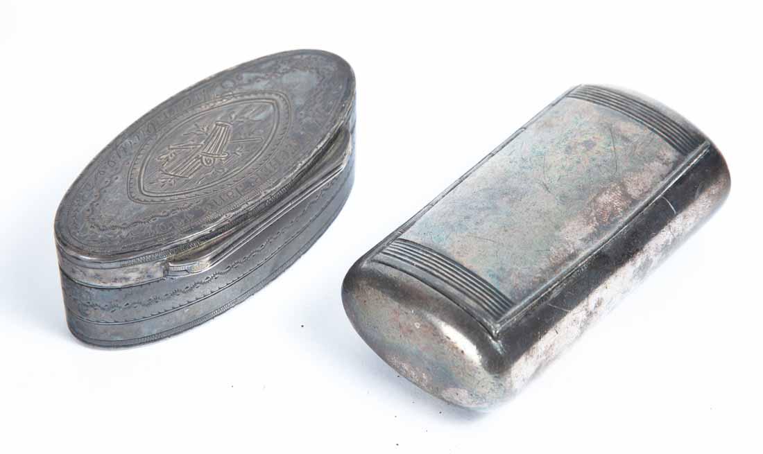 TWO SNUFF BOXES: Both metal, probably silverplate. One oval with engraved floral decoration and inscribed "E. Pitcher Jan. 1801, Thornburg". 3"w. One cylindrical with rounded end. Unidentified hallmarks. 3"w.