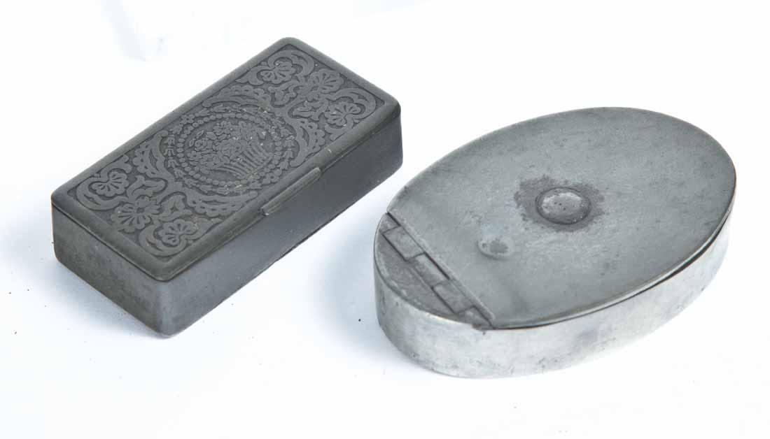 TWO PEWTER SNUFF BOXES: One with floral embossed lid and base. 3"w. One oval. 3.5"w.