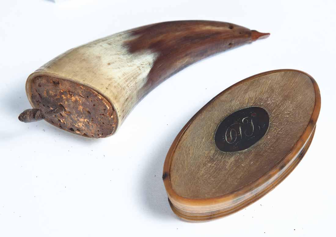 TWO HORN SNUFF BOXES: One powder horn-shaped with cork lid. 4"w. One oval with hinged lid and monogram tag. 3.5"w.