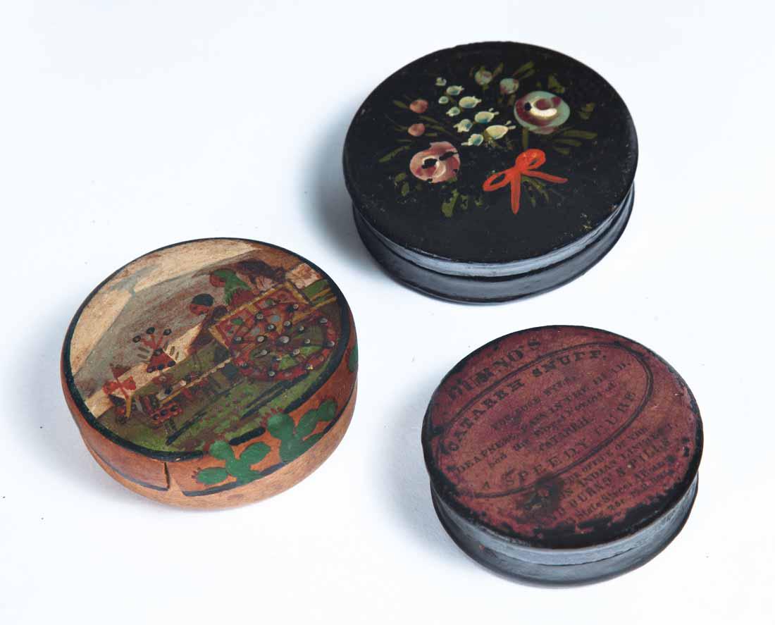 THREE ROUND SNUFF BOXES: One black lacquerware with painted floral decoration. 2.75"dia. One with snuff advertising on lid. 2.25"dia. One possibly made from an orange peel with handpainted scene on the lid. Marked "Taormina".