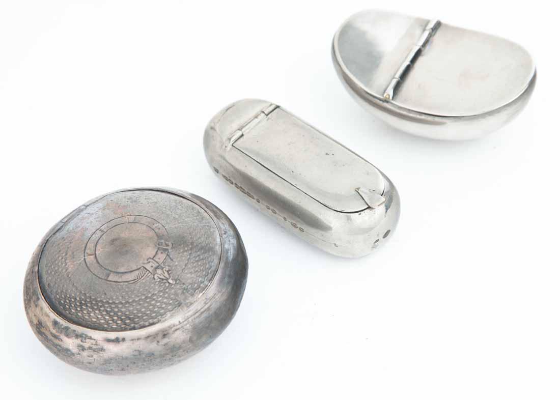 THREE SNUFF BOXES: All silverplate. One round with engraved lid. 3"dia. One kidney bean-shaped. 3"w. One cylindrical with flattened top and bottom. 3"w.