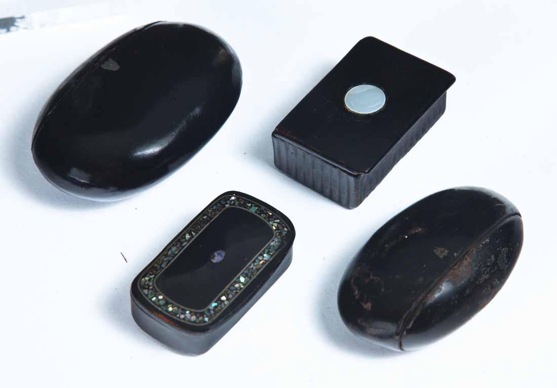 FOUR LACQUERWARE SNUFF BOXES: All black. Two oval with hinged side lids, one with small inset shield 2 .75"w. 3 .25"w. Two rectangular; both with mother of pearl inlay. 2.25"w.