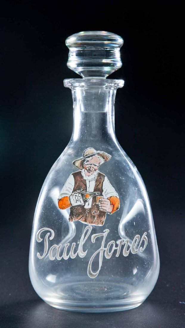 ENAMELED LABEL BAR BOTTLE: Colorless pinched body pre-Prohibition bottle with "Paul Jones" and image of old man with bottle and shot glass. Glass stopper with flattened top. 8"h.