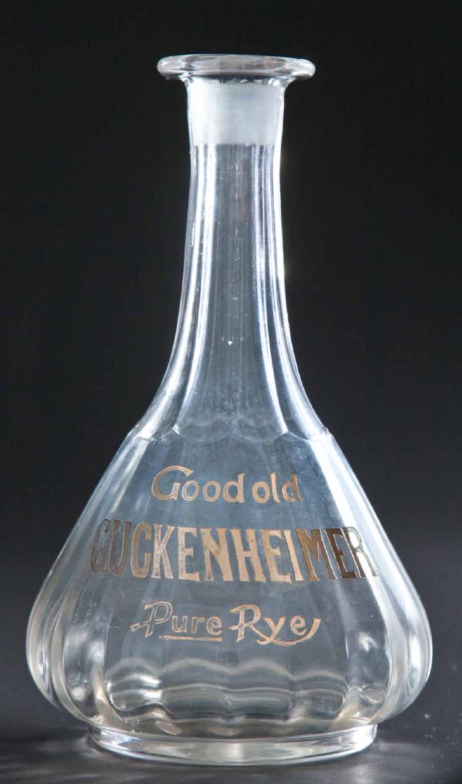 ENAMELED LABEL RYE BOTTLE: Colorless paneled pre-Prohibition bar bottle with "Good Old Guckenheimer Pure Rye" on front. No stopper. 9"h.
