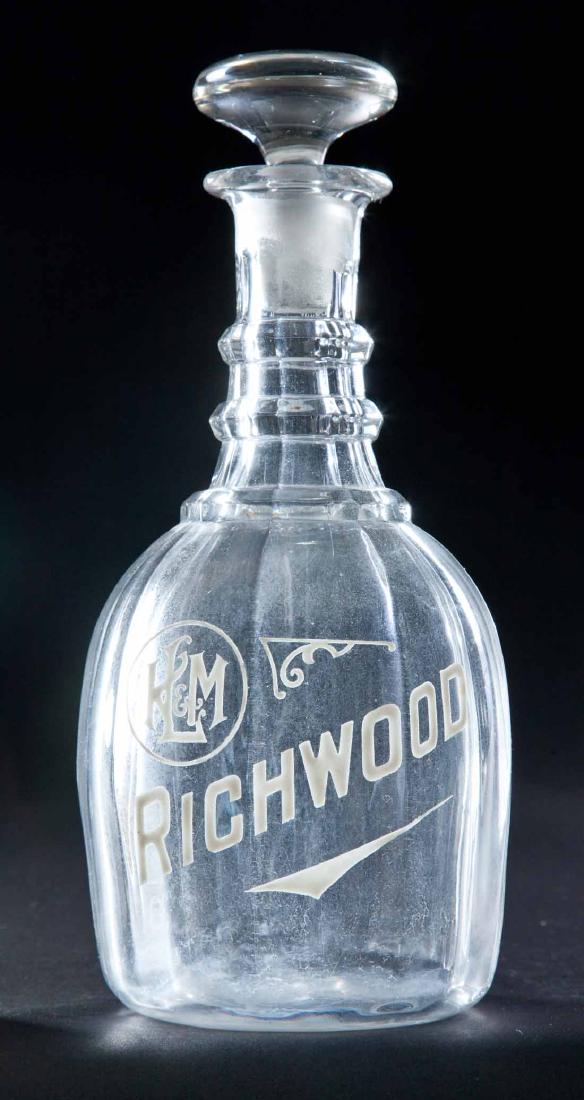ENAMELED LABEL BAR BOTTLE: Colorless paneled pre-Prohibition decanter with "H L & M Richwood" on front. Flat glass stopper. 10.5"h.