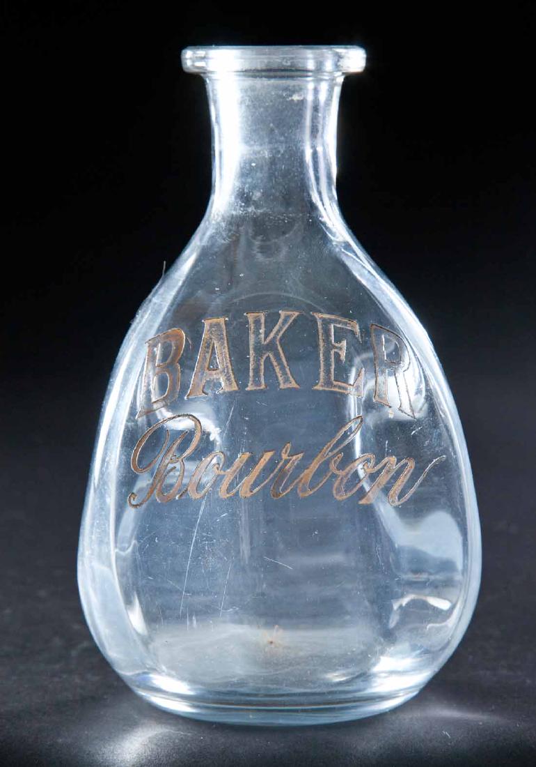 ENAMELED LABEL BOURBON BOTTLE: Colorless pre-Prohibition bottle with pinched body and label for "Baker Bourbon". 6.5"h.
