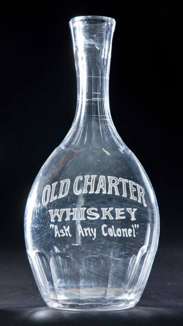ENAMELED LABEL WHISKEY BOTTLE: Colorless pre-Prohibition bottle with bulbous body, paneled neck and base and label for "Old Charter Whiskey, "Ask Any Colonel". 9"h.