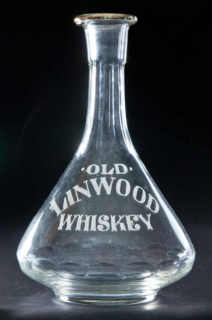 ENAMELED LABEL WHISKEY BOTTLE: Colorless pre-Prohibition decanter with flared body, paneled neck and "Old Linwood Whiskey". 9.5"h.