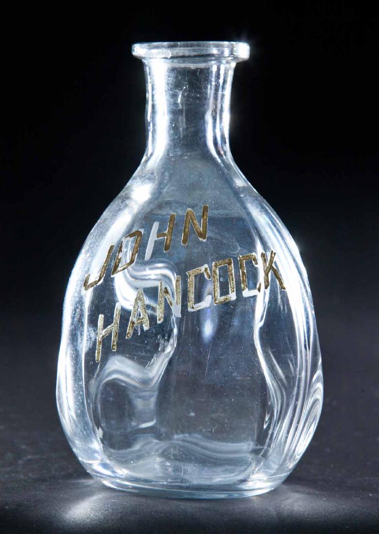 ENAMELED LABEL BAR BOTTLE: Colorless pre-Prohibition bottle with pinched body and label for "John Hancock". 6.5"h.