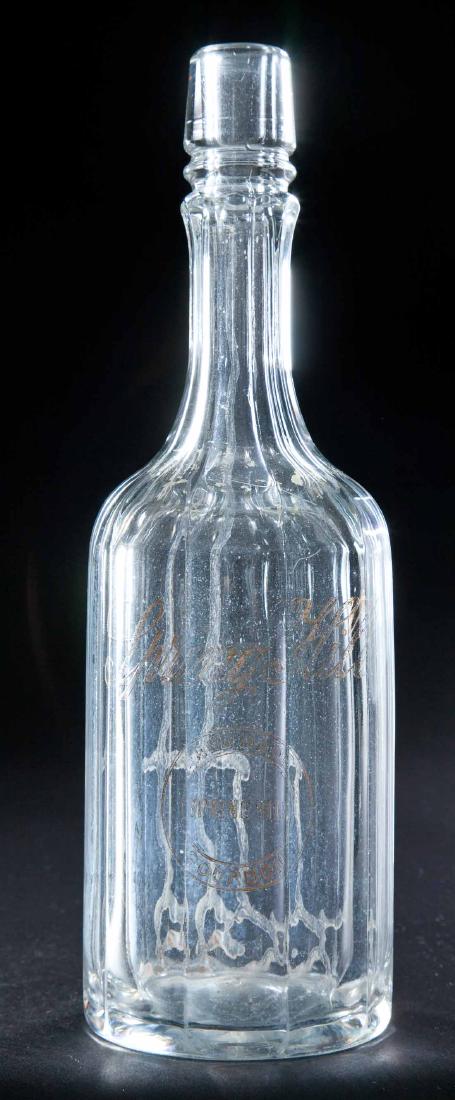 ENAMELED LABEL BOURBON BOTTLE: Colorless pre-Prohibition bottle with paneled body and neck and "Spring Hill Hand Made Bourbon" label. 11.5"h.