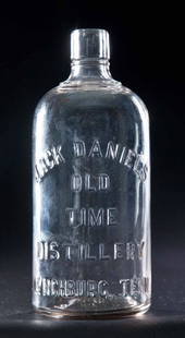 JACK DANIEL'S OLD TIME WHISKEY BOTTLE: Colorless glass cylinder whiskey bottle, quart capacity, embossed "Jack Daniel's Old Time Distillery, Lynchburg, Tenn.". 8.75"h.