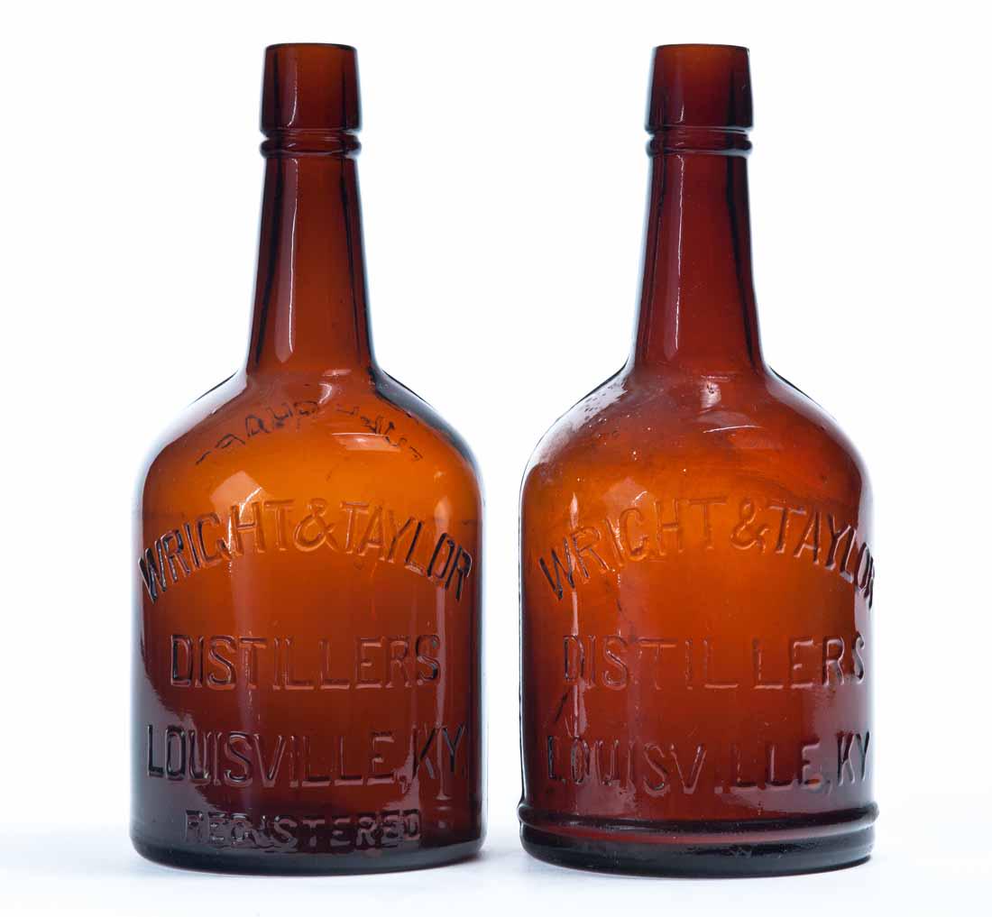 TWO FULL QUART AMBER WHISKEY BOTTLES: Both pre-Prohibition with embossed labels for "Wright & Taylor, Distillers, Louisville, KY, Registered". 9.75"h.