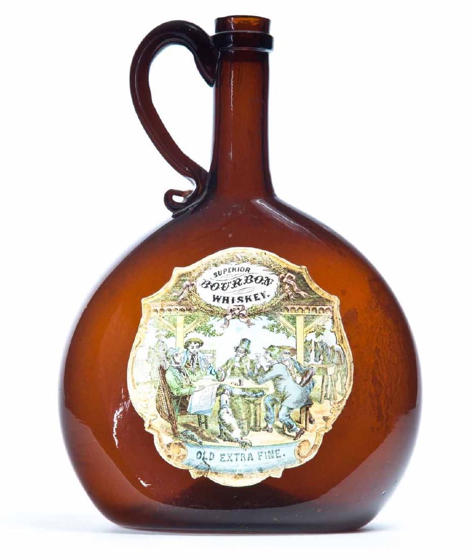 BLOWN AMBER WHISKEY FLASK: Pre-prohibition chestnut-form flask with flattened body, attached handle, pontil maerk, and original paper label for "Superior Bourbon Whiskey". 8.75"h.