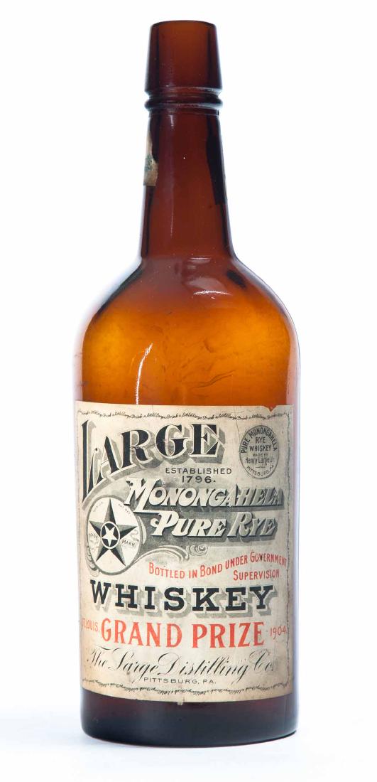 AMBER WHISKEY BOTTLE: Quart-size pre-Prohibition bottle with original label "Large Monongahela Pure Rye Whiskey Grand Prize 1904". Original "Distilled Spirits Notices" on reverse. 11.5"h.