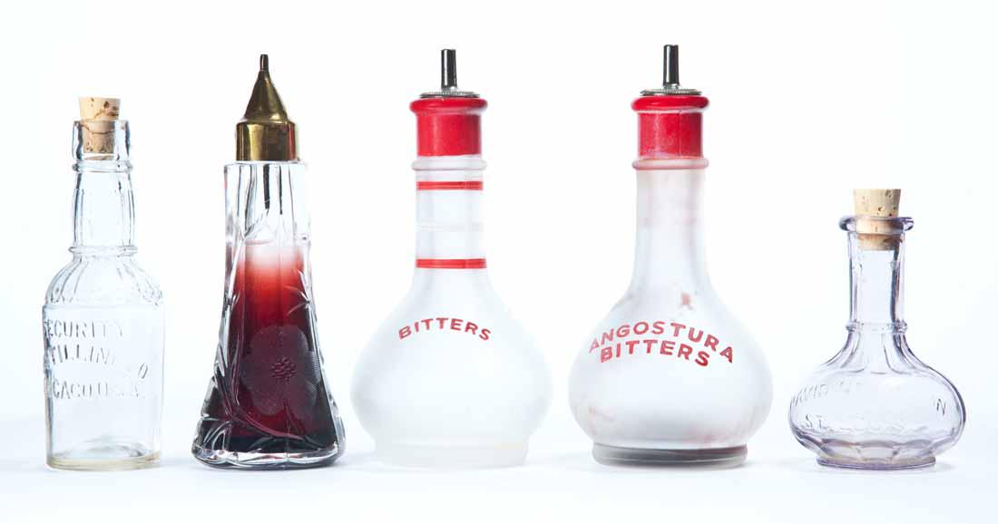 FIVE MINIATURE BOTTLES: Lot includes two frosted "Bitters" bottles with dash darts. 6"h. Embossed label "David Nicholson, St. Louis" sample bottle. 3.25"h. Embossed label "Security Distilling Co, Chicago, USA" sample bottle.