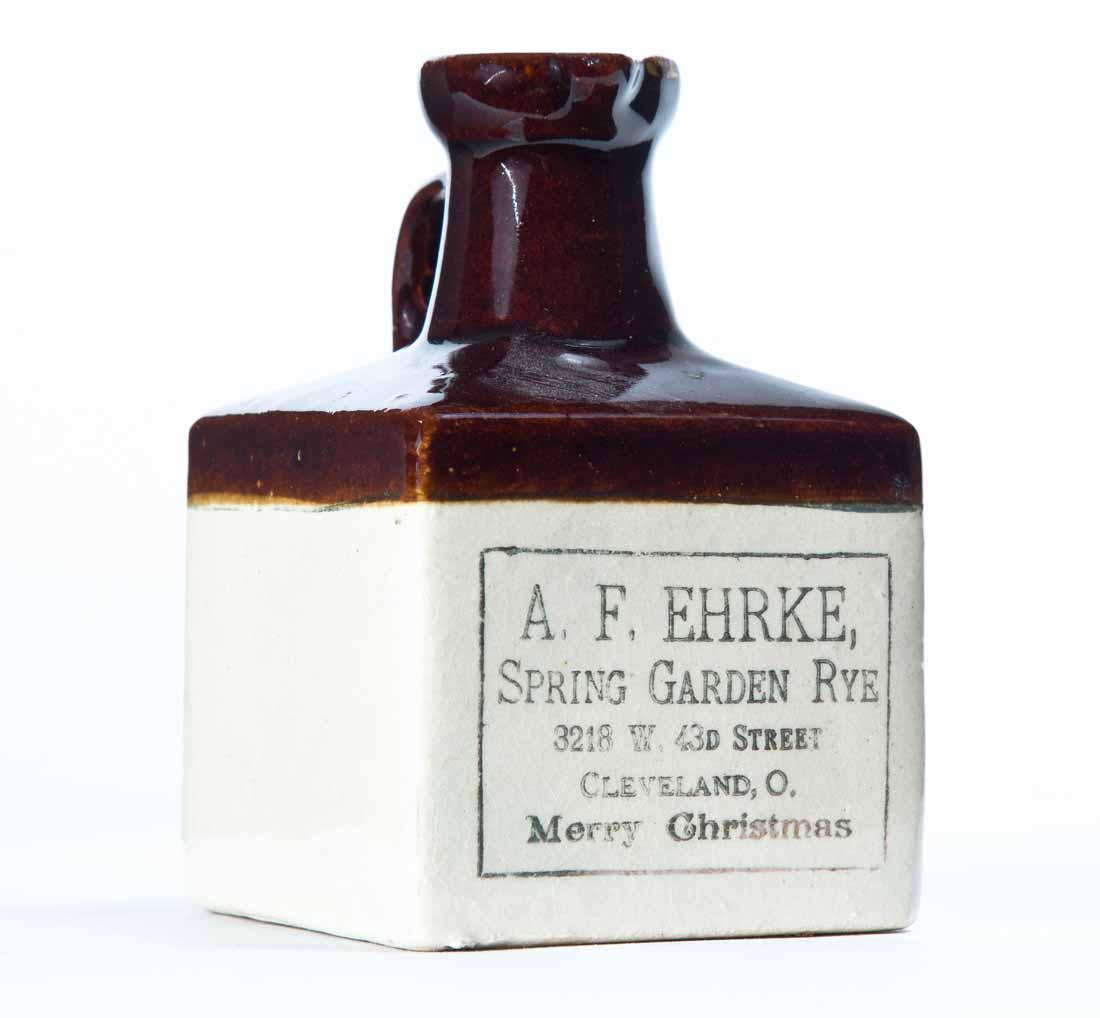 CLEVELAND, OHIO MINIATURE ADVERTISING STONEWARE JUG: Bicolor glaze with stamped advertisement ".F. EHRKE, SPRING GARDEN RYE" and "Merry Christmas." 4.25" high.