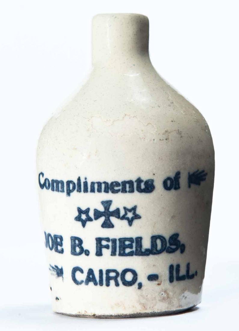 CAIRO, ILLINOIS MINIATURE ADVERTISING JUG: Cream glaze and stamped advertisement "Compliments of JOE B. FIELDSâ€¦" 3.25" high.