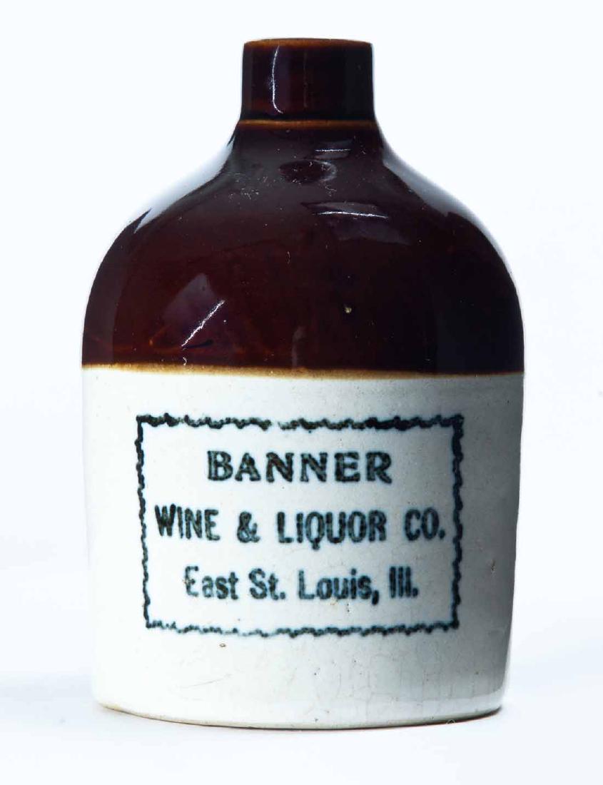 ST. LOUIS, MISSOURI MINIATURE ADVERTISING JUG: Bicolor glaze with stamped advertisement "BANNER WINE & LIQUOR COâ€¦" 4.25" high.