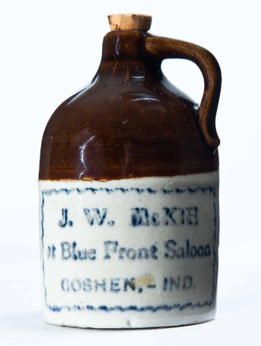 GOSHEN, INDIANA MINIATURE ADVERTISING JUG: Bicolor glaze and stamped advertisement "J.W. McKIEâ€¦" 3.25" high.