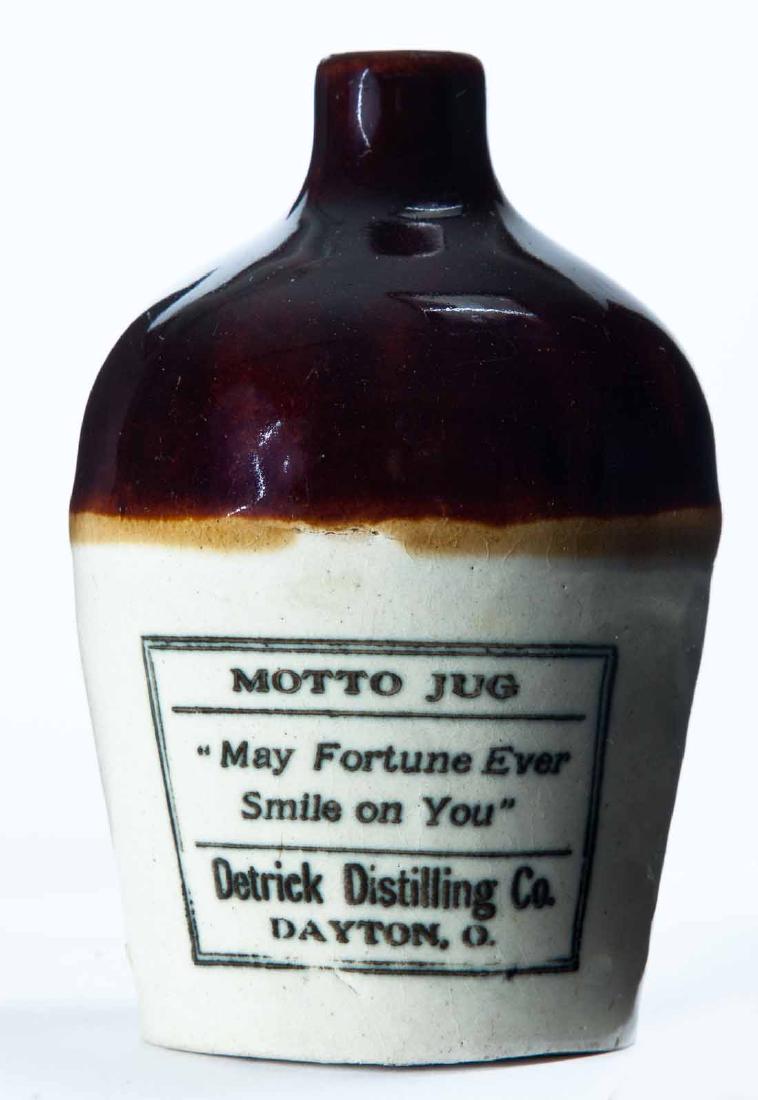 DAYTON, OHIO MINIATURE ADVERTISING JUG: Bicolor glaze and stamped advertisement "MOTTO JUG 'May Fortune Ever Smile on You' DETRICK DISTILLING COâ€¦" 4.5" high.