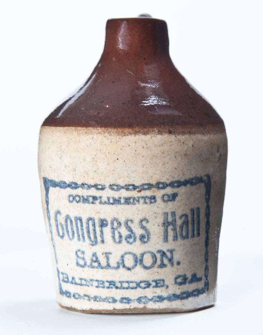 BAINBRIDGE, GEORGIA MINIATURE ADVERTISING JUG: Bicolor glaze and stamped advertisement "COMPLIMENTS OF Congress Hall Saloon." 3.25" high.