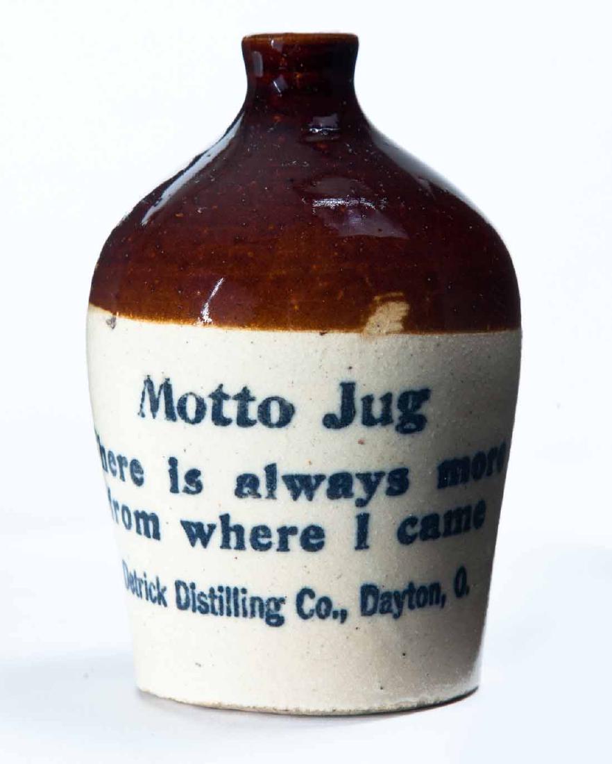 DAYTON, OHIO MINIATURE ADVERTISING JUG: Bicolor glaze and stamped advertisement "Motto Jug There is always more from were I came Detrick Distilling Coâ€¦" 4.5" high.