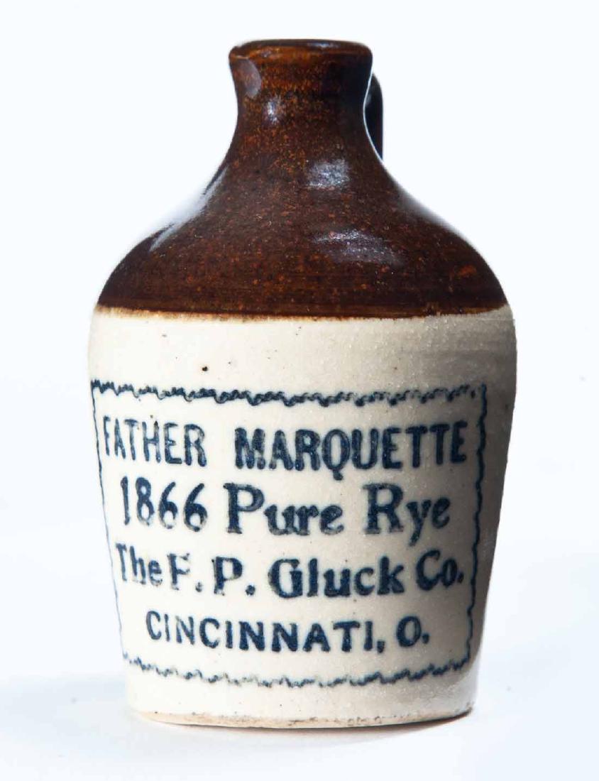 CINCINNATI, OHIO MINIATURE ADVERTISING JUG: Bicolor glaze and stamped advertisement "FATHER MARQUETTE 1866 Pure Ryeâ€¦" 3.25" high.