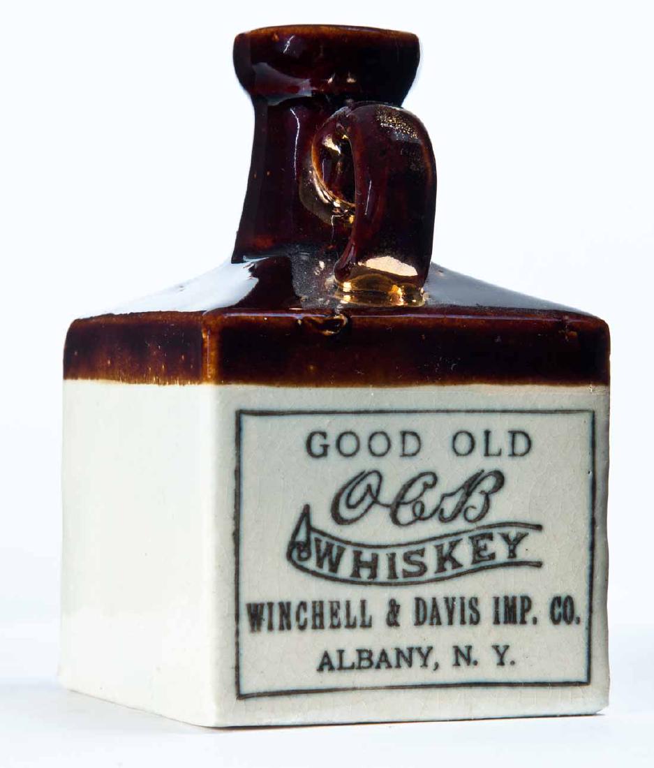 ALBANY, NEW YORK MINIATURE ADVERTISING JUG: Bicolor glaze and stamped advertisement "GOOD OLD OCB WHISKEY WINCHELL & DAVIS IMP. COâ€¦" 4.25" high.