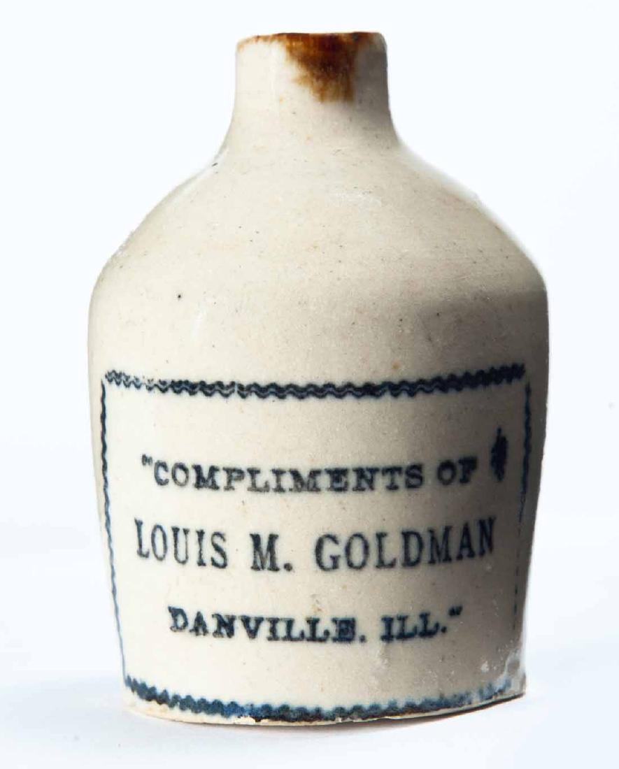 DANVILLE, ILLINOIS MINIATURE ADVERTISING JUG: Cream glaze and stamped advertisement "COMPLEMENTS OF LOUIS M. GOLDMANâ€¦" 3" high.