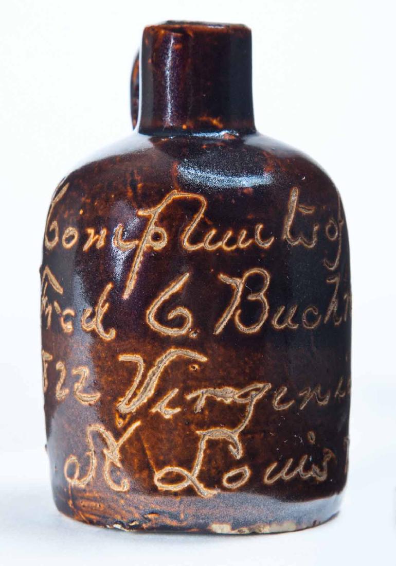 ST. LOUIS, MISSOURI MINIATURE ADVERTISING JUG: Scratch-decorated advertisement "Compliments of Fred G. Bucktruckerâ€¦" 3.25" high.