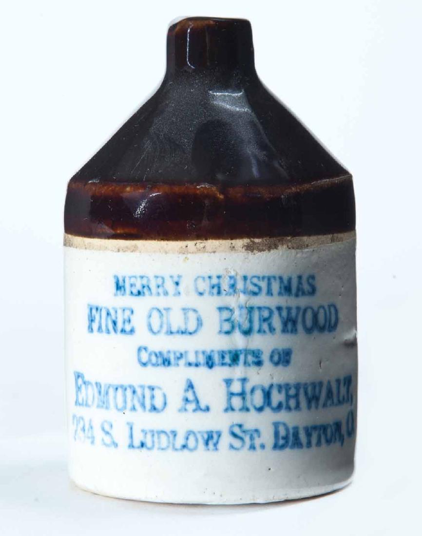 DAYTON, OHIO MINIATURE ADVERTISING JUG: Bicolor glaze and stamped advertisement "MERRY CHRISTMAS FINE OLD BURWOOD COMPLIMENTS OF EDMUND A. HOCHWALZâ€¦" 3.5" high.
