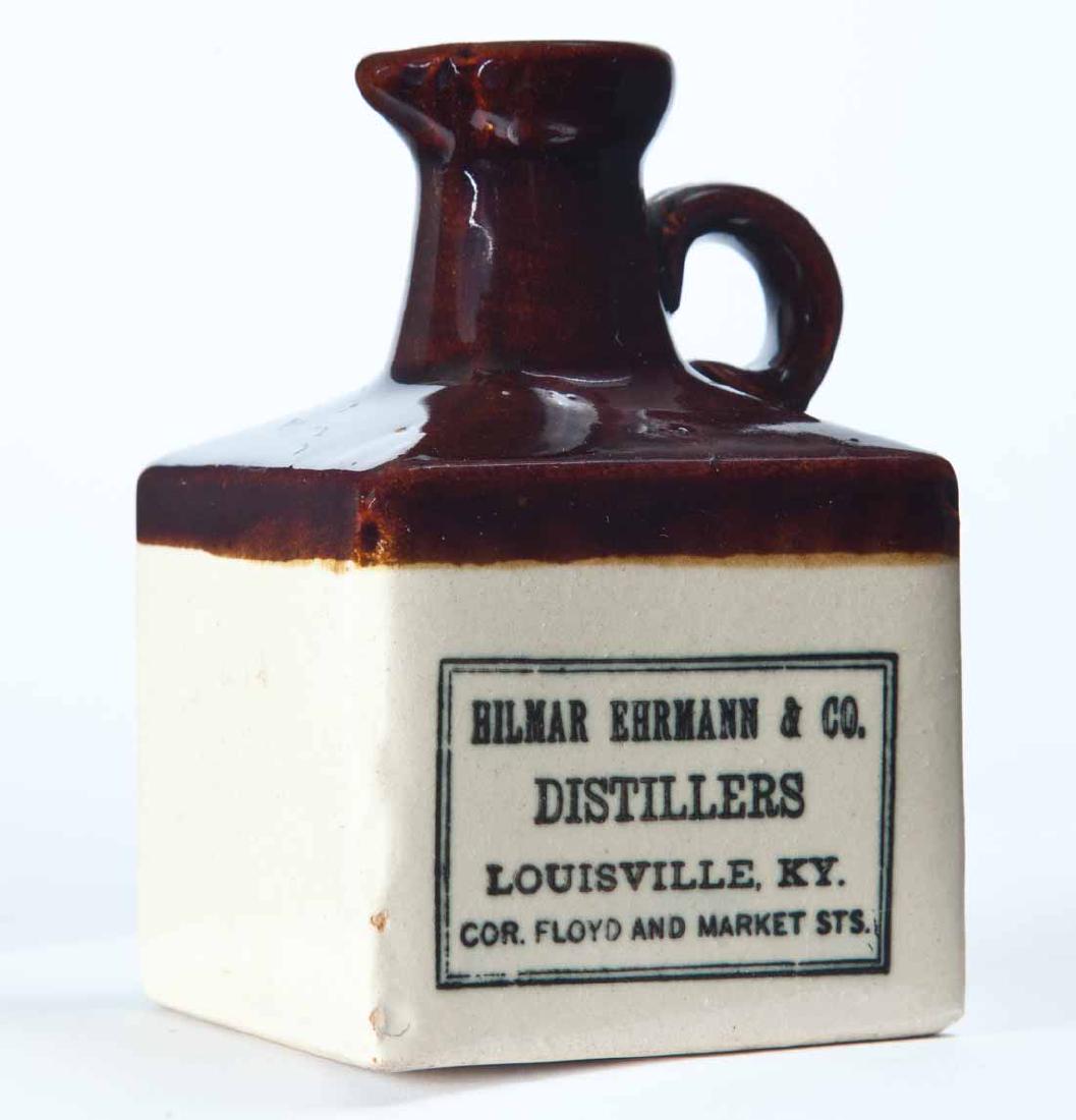LOUISVILLE, KENTUCKY MINIATURE ADVERTISING JUG: Bicolor glaze and stamped advertisement "HILMAR EHRMANN & CO. DISTILLERSâ€¦" 4.25" high.